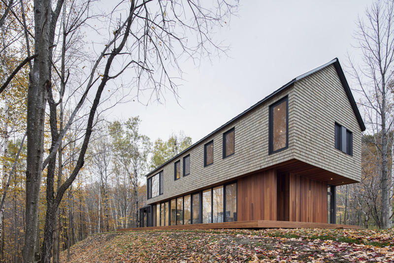 This cedar shingled house is at home surrounded by the forest in Quebec