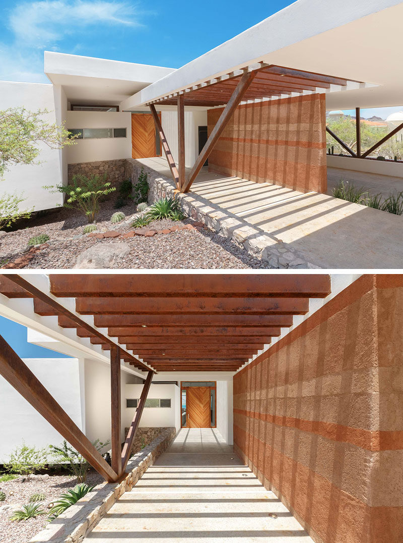 This home in Mexico features a rammed earth wall that separates the carport from the front entrance.