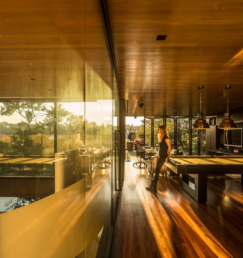 The wood ceiling flows from one room to another in this Brazilian house.