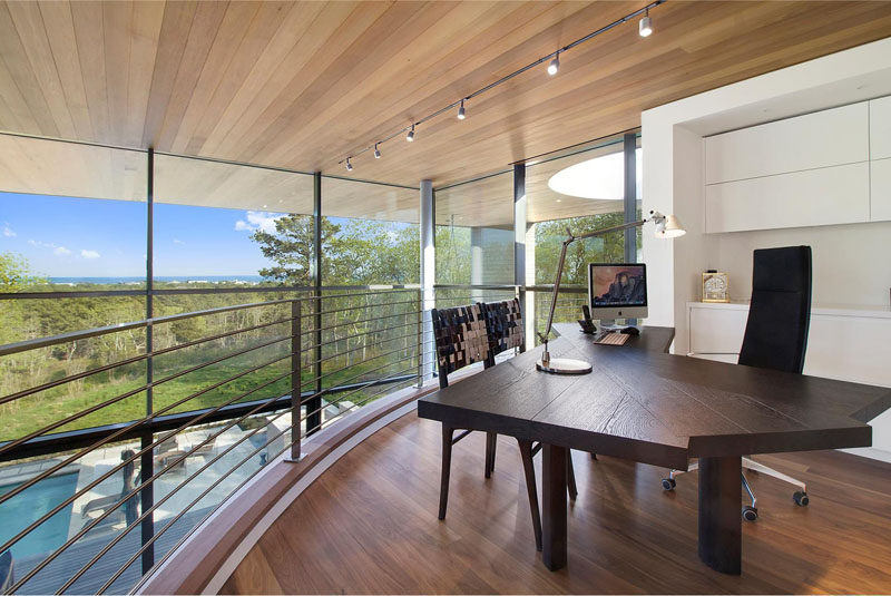 This home office has amazing views, and overlooks the swimming pool below.
