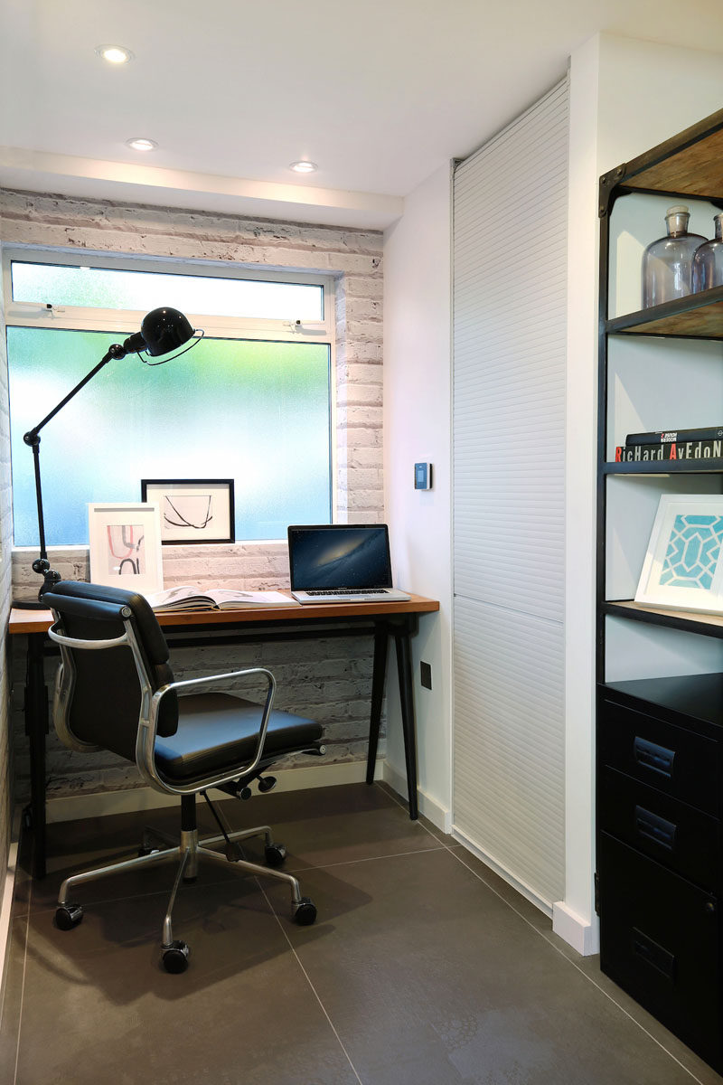 Distressed white brick wallpaper gives this small office area a feeling of texture.