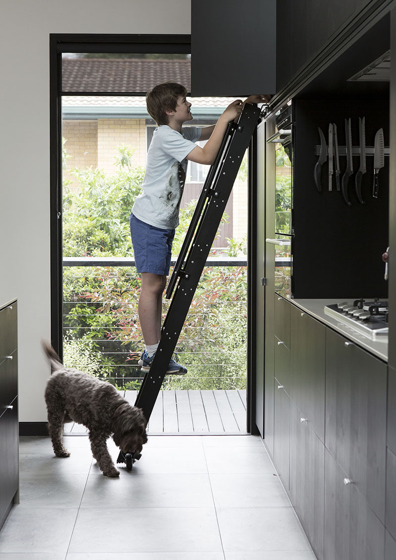 This Matte Black Kitchen Has A Rolling Ladder To Reach The Upper Cabinets