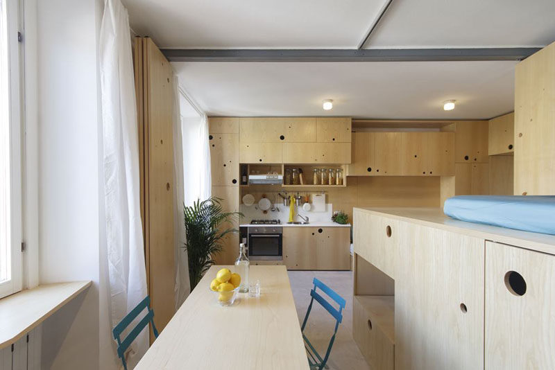 This tiny apartment has a lounge, kitchen, dining room, lofted bed and a bathroom.