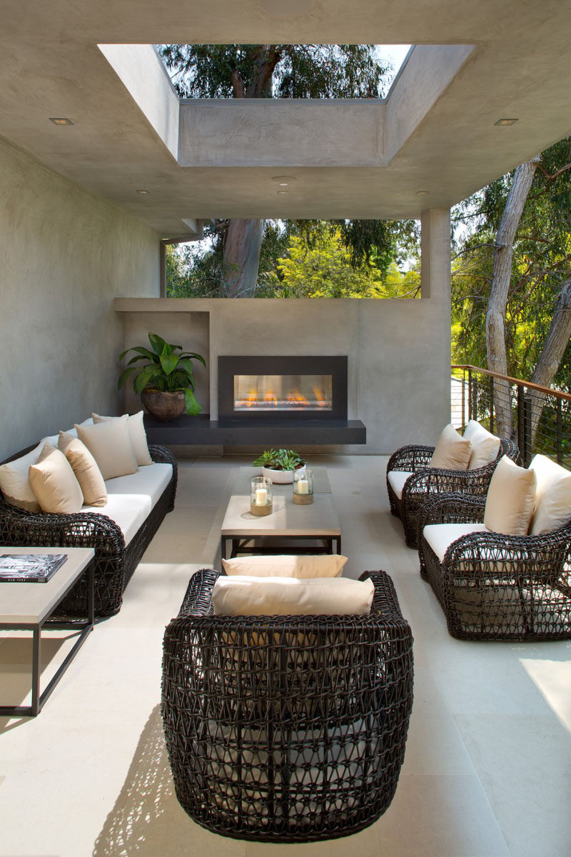 This partially covered outdoor lounge has a fireplace to enjoy when it gets cool.