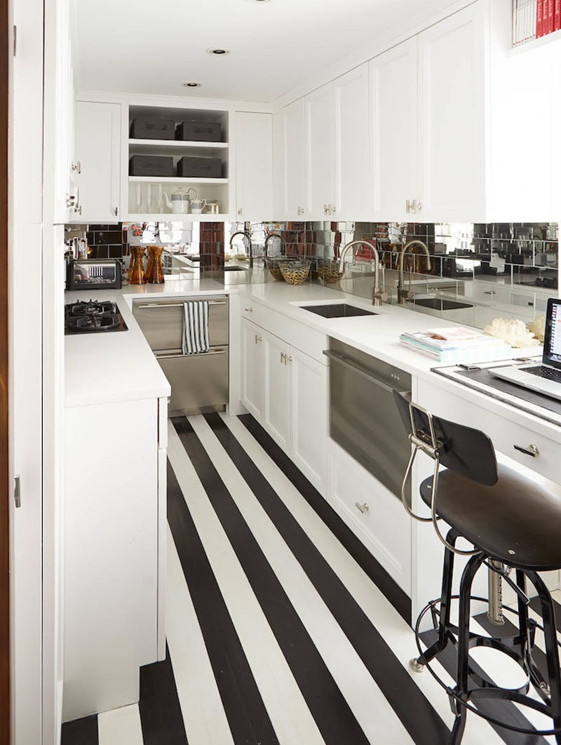 7 Examples Of Striped Floors In Contemporary Homes // The black and white stripes in this tiny kitchen elongate it, and create the illusion that the kitchen is bigger than it actually is.