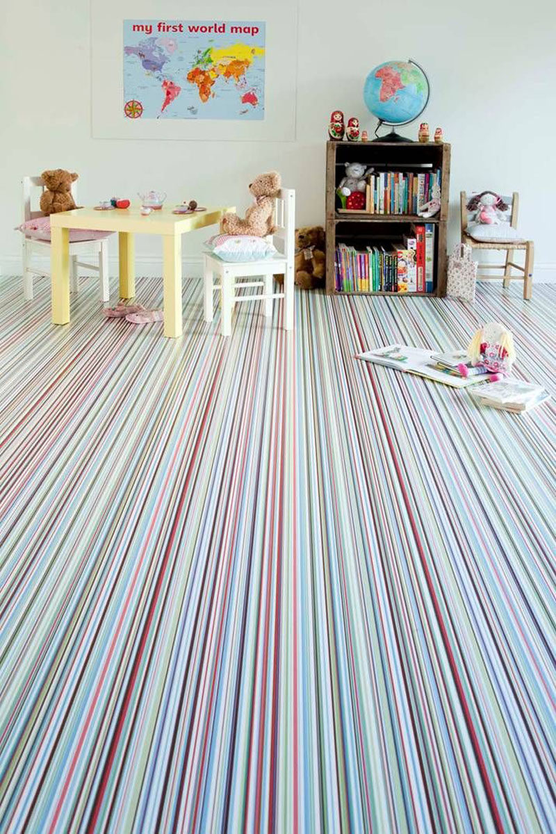 7 Examples Of Striped Floors In Contemporary Homes // This playroom is made even more fun with the wall to wall thinly striped carpet in bright colors.