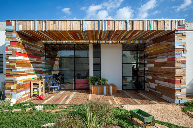 Often white stucco houses are just that, white stucco, but with this house, the white stucco walls have been broken up by an artistic yet function scrap wood element, that makes a fun artistic statement.