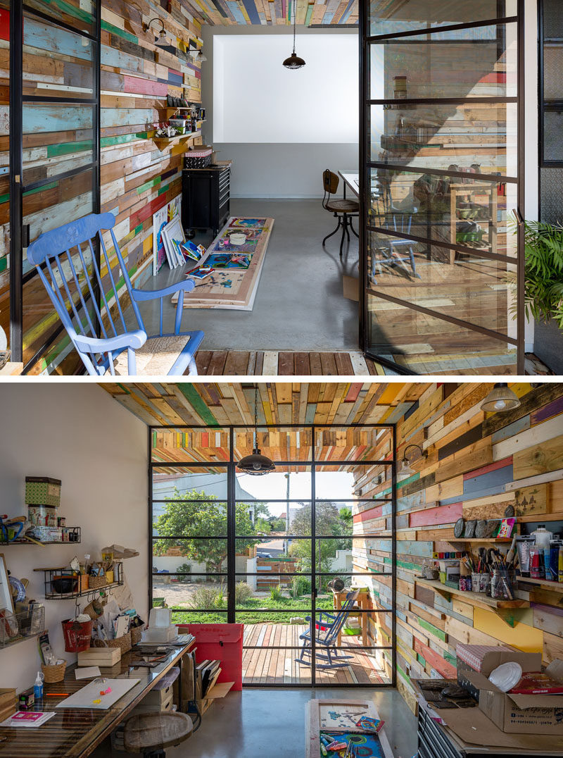 This home's covered patio provides access to an art studio, where the scrap wood feature wall flows through seamlessly to the inside of the home.