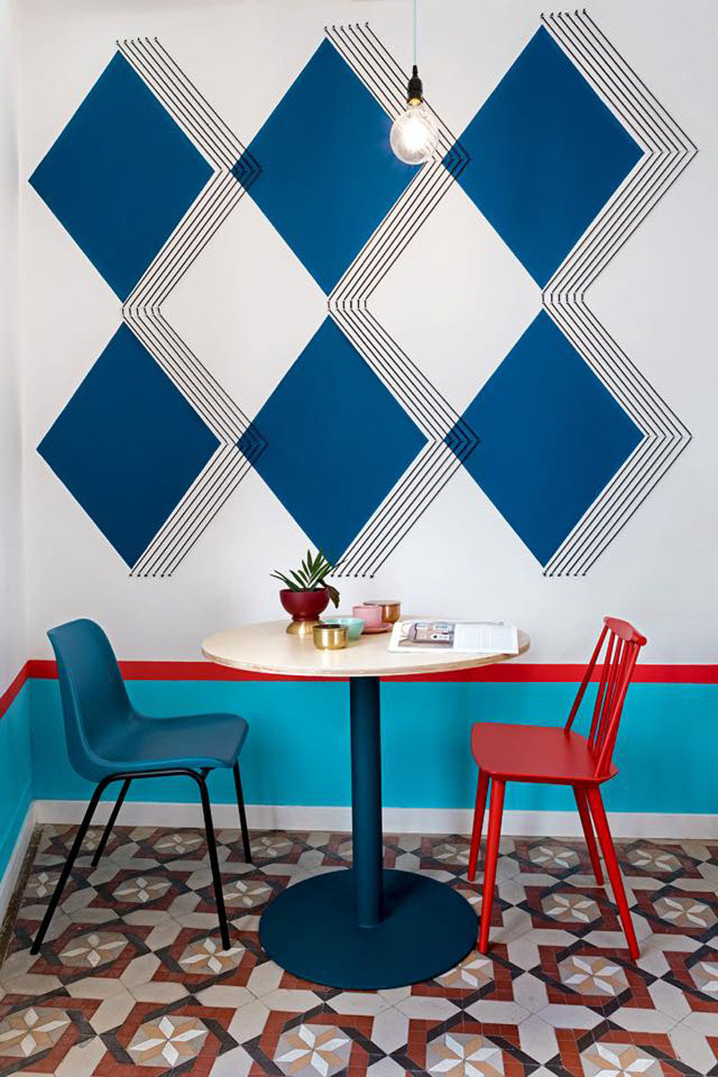 Wall Decor Inspiration - Bold Graphics Cover The Walls Of This Spanish Hostel // Large blue diamonds feature on this wall with black stripes adding to the 3-dimensional look of the diamonds.