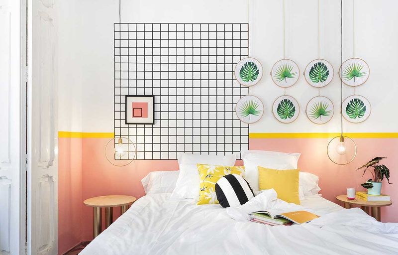 Wall Decor Inspiration - Bold Graphics Cover The Walls Of This Spanish Hostel // Botanical inspired art is paired with a black grid to decorate this hostel room.