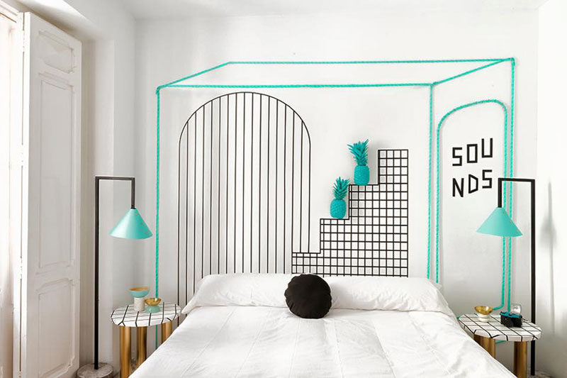 Wall Decor Inspiration - Bold Graphics Cover The Walls Of This Spanish Hostel // Turquoise and black graphics and lamps stand out in this white hostel room.