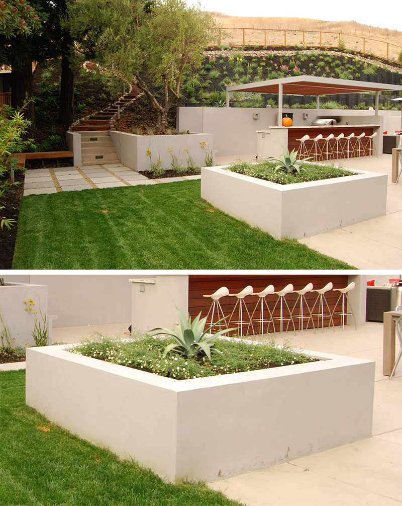 10 Inspirational Ideas For Including Custom Concrete Planters In Your Yard // The large square concrete planter in this yard divides the entertaining area from the the rest of the garden, and looks great while doing it.