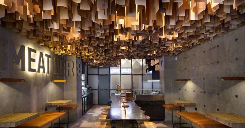 Wood Veneers Suspended From The Ceiling Create A Dramatic Effect