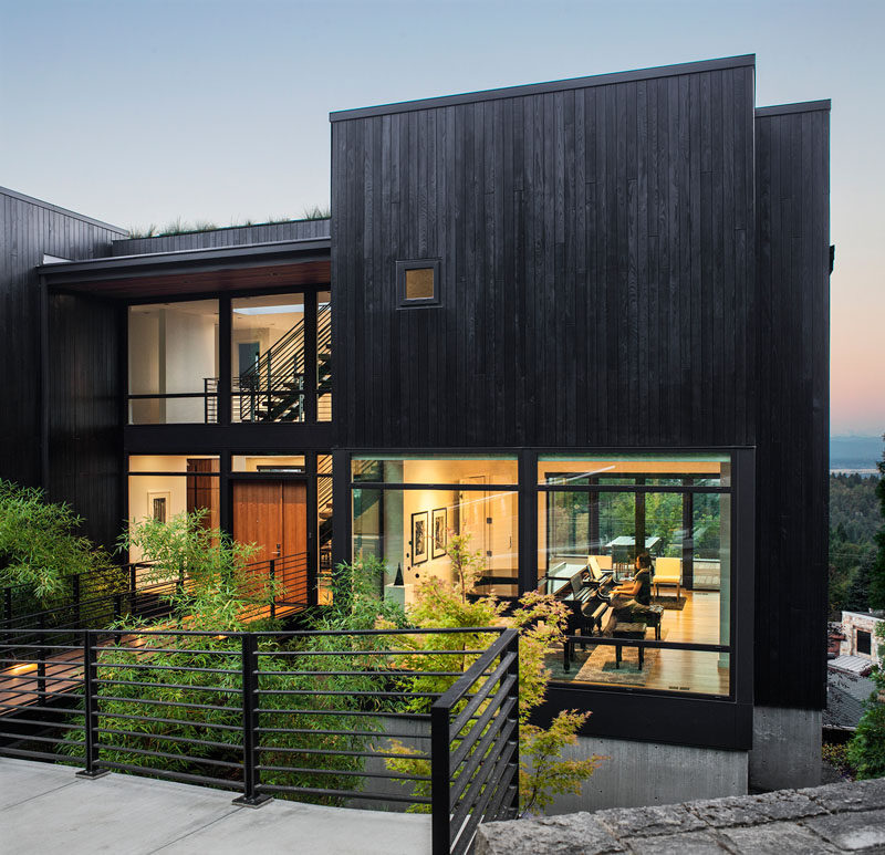 The exterior of the home is clad in black stained siding; reminiscent of Shou Sugi Ban or charred wood, which pays homage to the family's Japanese ancestry. 