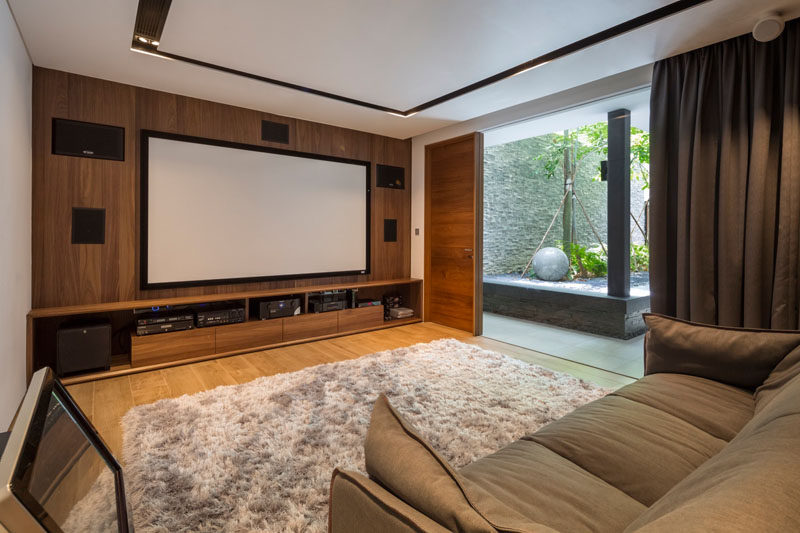 This entertainment room has a built-in wall unit for surround sound, and there's also access to a small landscaped yard.