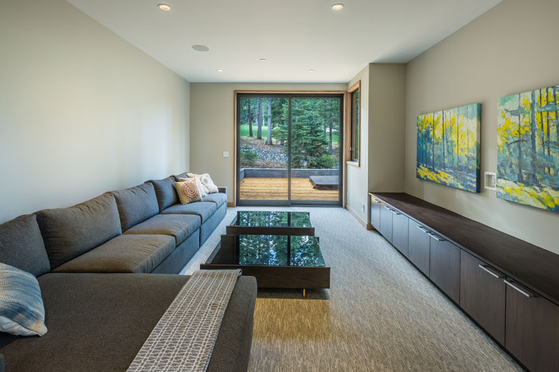 This media room has access to the deck outside through glass sliding doors.