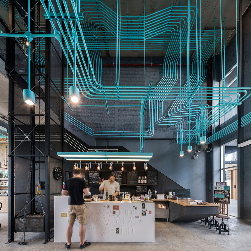 Turquoise electrical conduit is a design feature running through this office space
