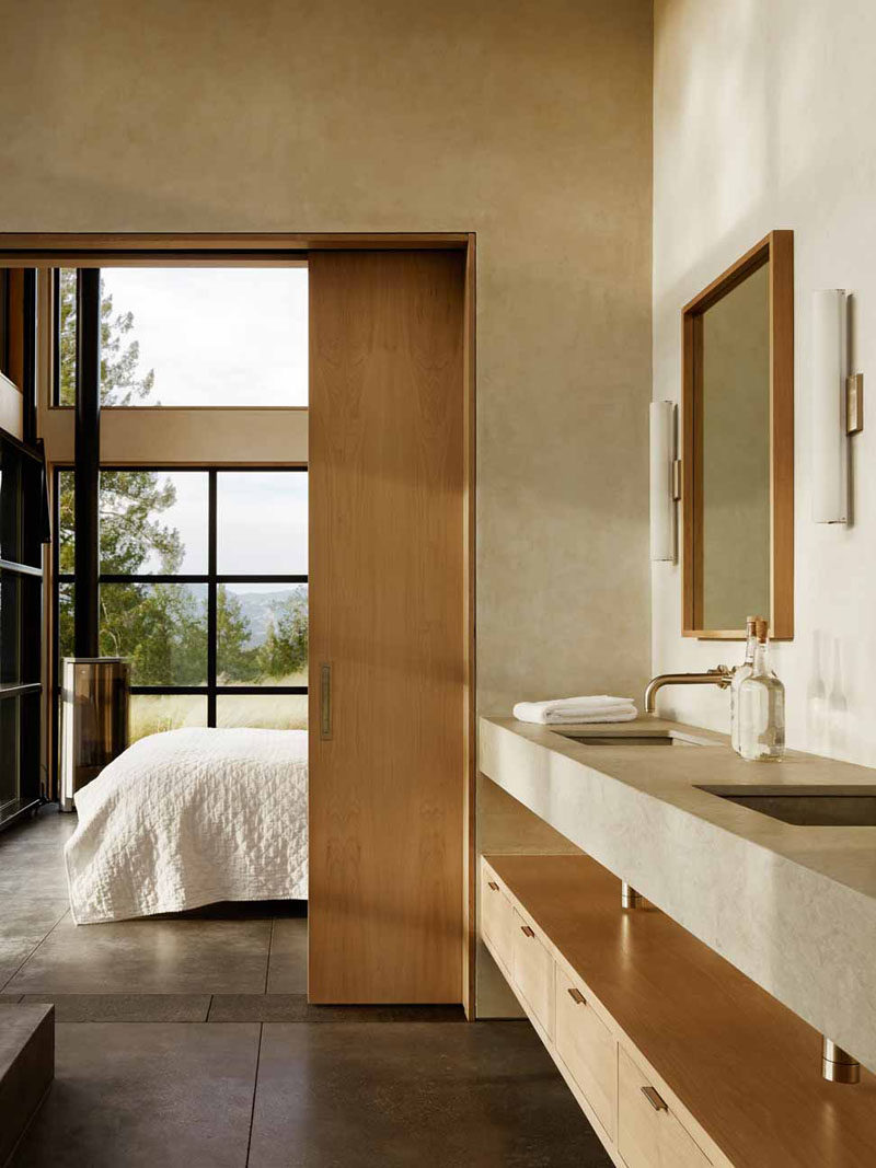 A wooden pocket door separates the bedroom from the bathroom and saves room.