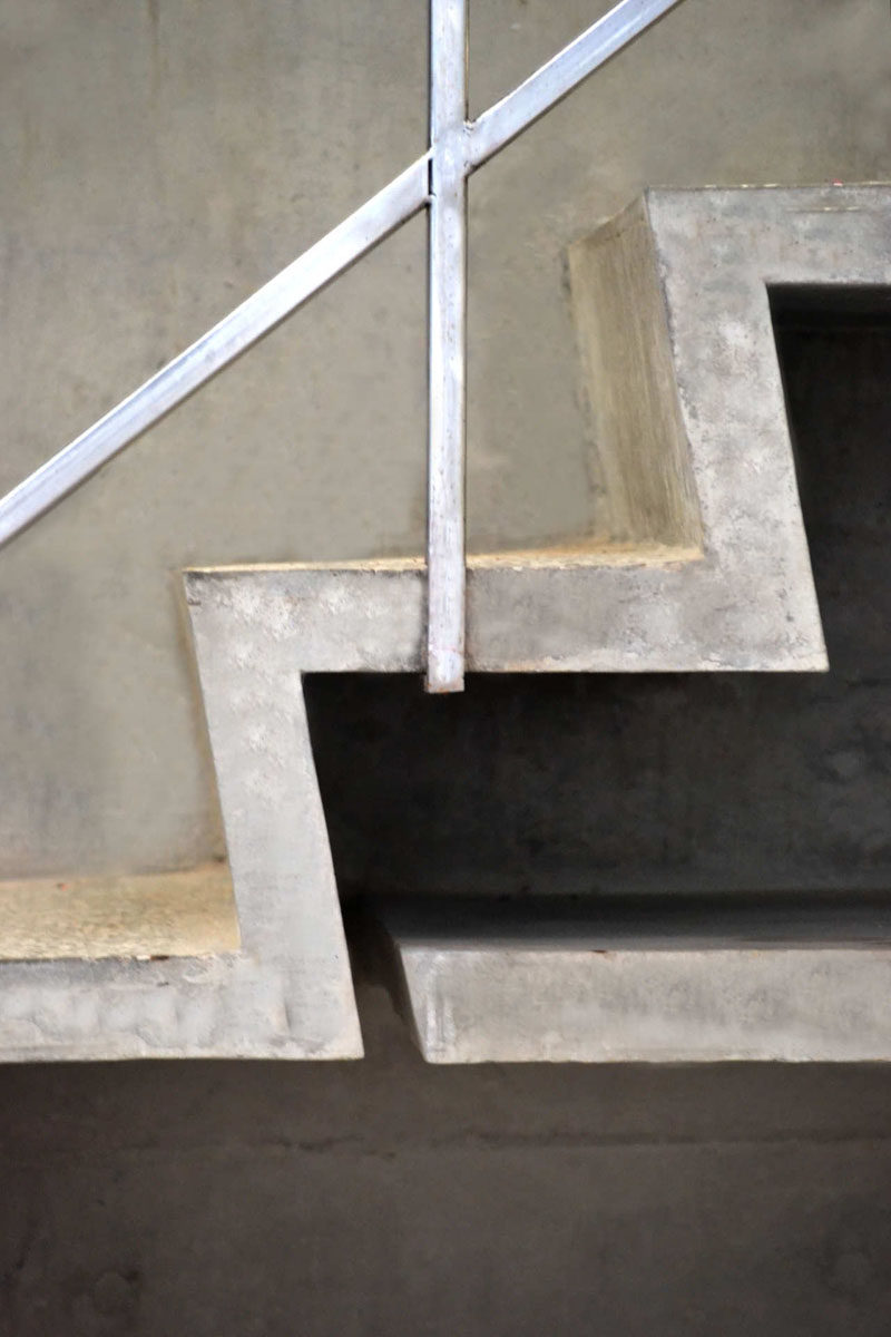 Interior Design Details - Industrial Close Ups // Concrete steps and thin metal handrails give this staircase a simple, modern, industrial look.