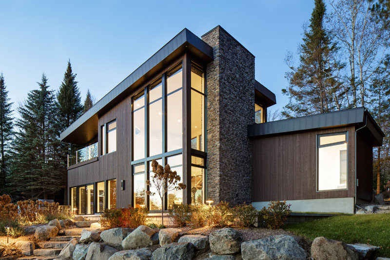 This modern lake house in Canada has an exterior clad in wood, stone, and metal