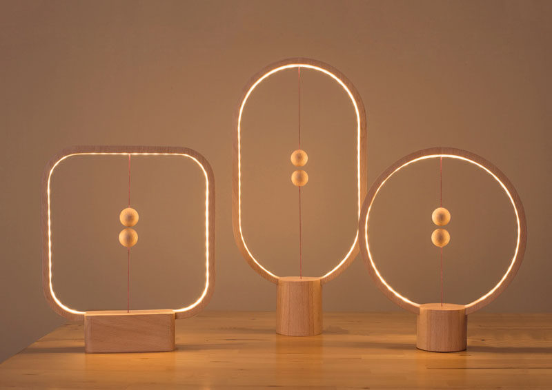 The Heng Balance Lamp, designed by Li Zanwen, is a table lamp made from high quality wood and two magnetic balls attached to an internal switch that's designed to make brightening all of your spaces a little more fun and a little less mundane.