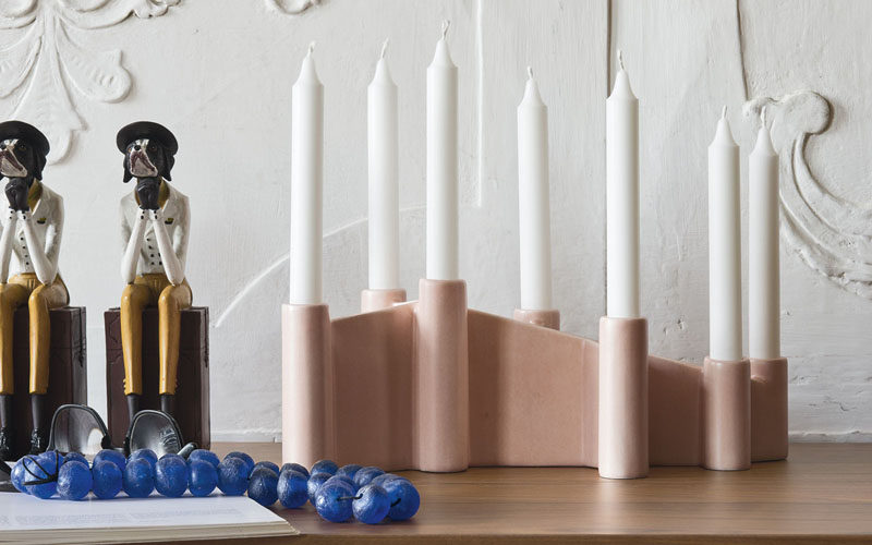 Brighten up your home with 7 candles that sit in a single ceramic holder.