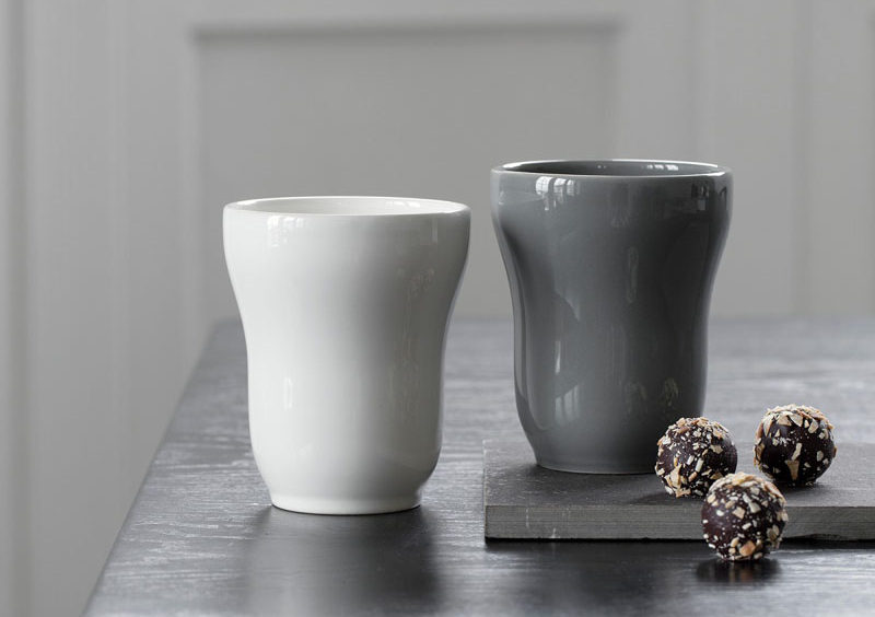 Modern ceramic mugs in grey and white with a smooth glossy finish.