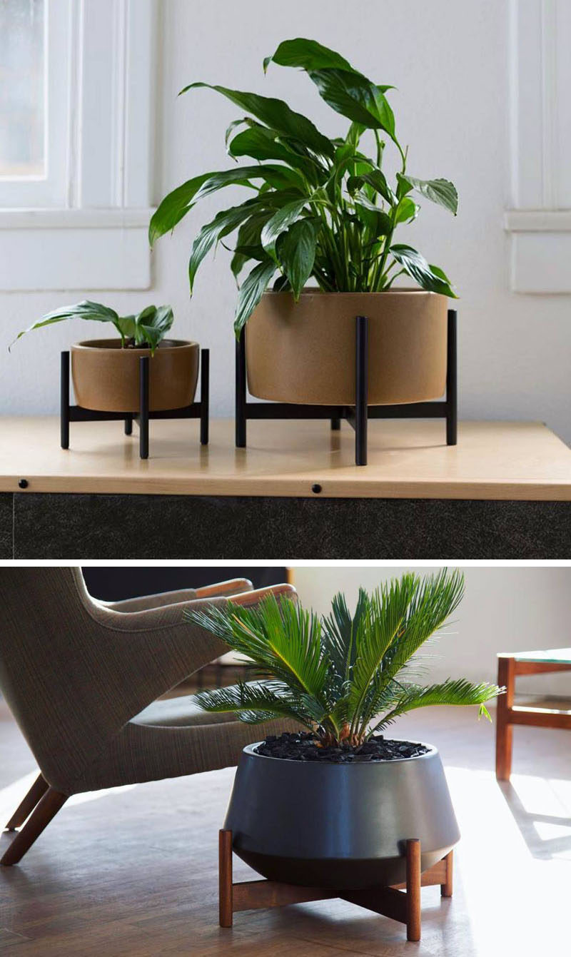 Ceramic planters with wooden stands.