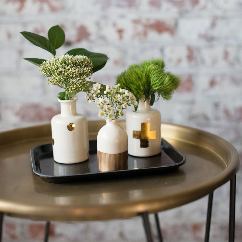 Small bud vases like these white and gold ones are great for displaying small flowers.