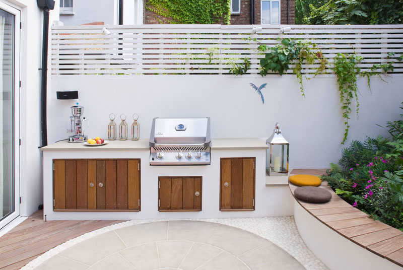 This modern landscaped garden has a bespoke outdoor kitchen with a bbq, counter space and storage. The garden also has a sound and lighting system as well as automatic irrigation.