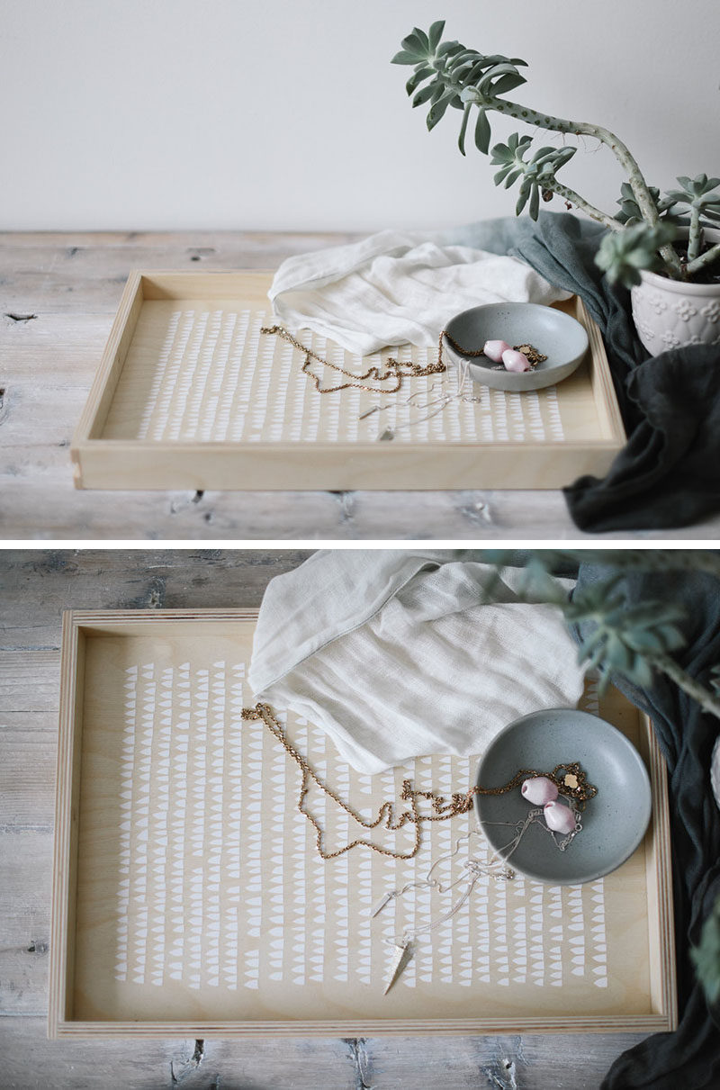  The minimalist white design on the inside of this light wood tray adds a whimsical touch while still keeping the look of the tray modern and clean.