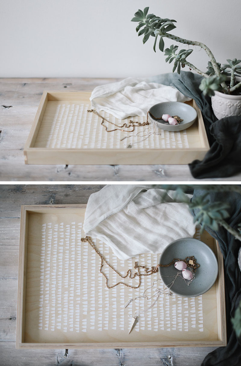 The minimalist white design on the inside of this light wood tray adds a whimsical touch while still keeping the look of the tray modern and clean.