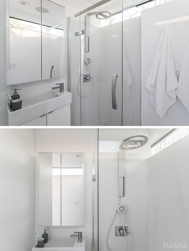 In this modern tiny home is a small bathroom with a shower, toilet and vanity.