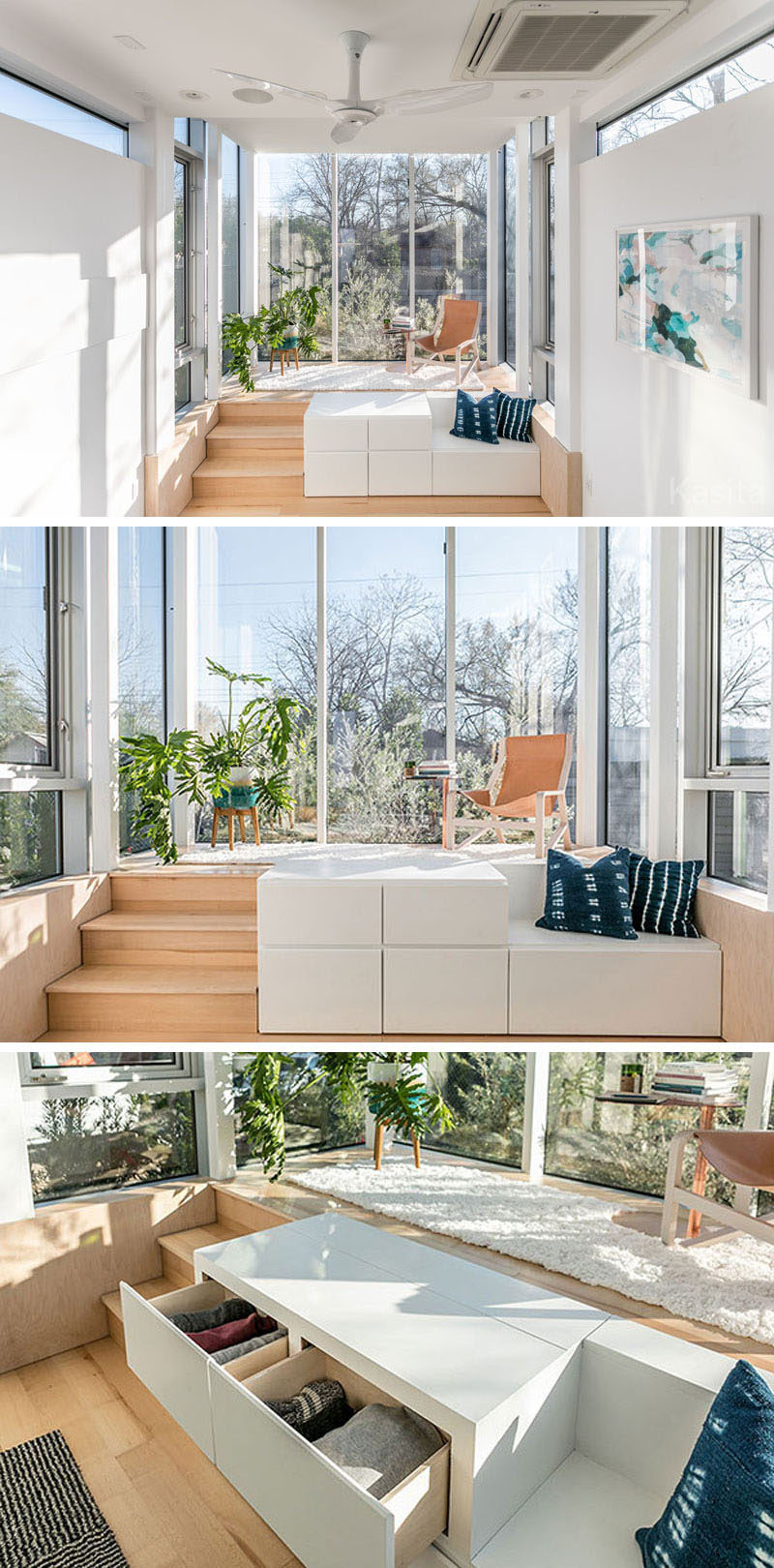 In this modern tiny house, there's a raised platform that's surrounded by floor to ceiling windows, allowing plenty of light to fill the small space. A flat-screen television is hidden within the white storage cube with drawers, that also has a small bench next to it. 