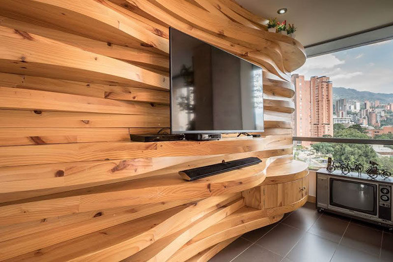 A Wavy Wood Accent Wall Creates Multiple Shelves In This ...