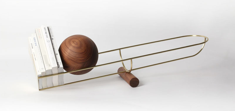 This Bookshelf Design Uses A Wood Ball To Keep Books In Place