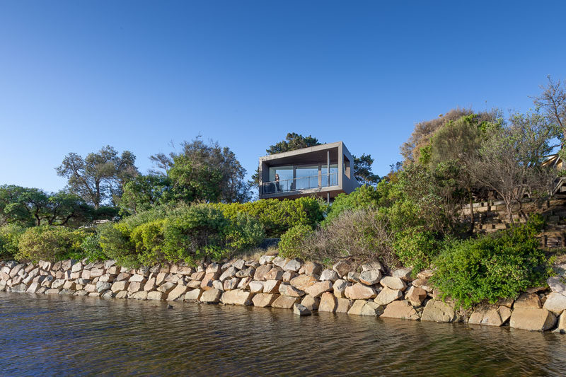 Open Studio Pty Ltd Architecture have created a modern house near Melbourne, Australia, that's surrounded by water and bushland, and was designed for a couple, their dog and visiting friends and family.