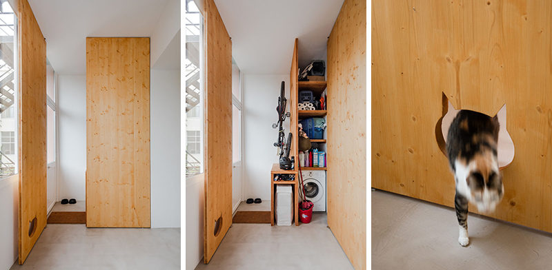 This small and modern apartment has a closet to hide away the washing machine and cleaning products, and when the door is closed, it reveals a cut-out in the door that doubles as a cute cat door.