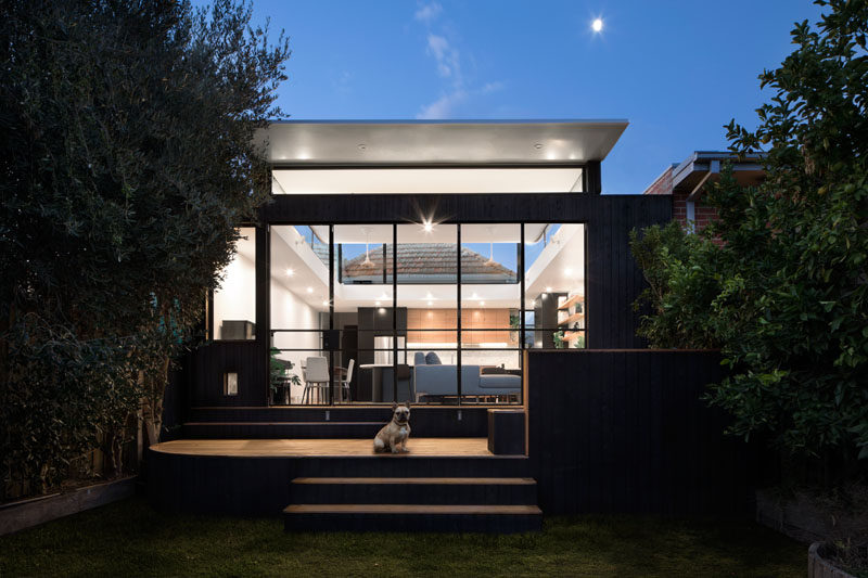 This modern house extension has the roof 'popped' up from the structure, and it allows for clerestory windows to let the light in and provides a view of the original home.