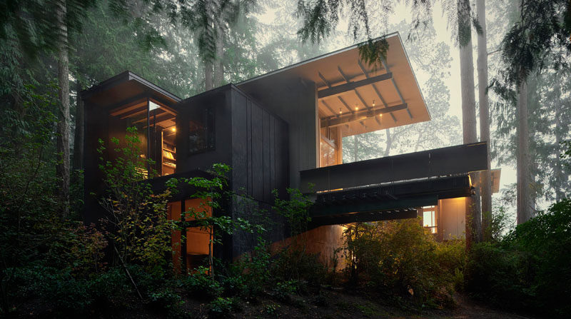 This modern cabin in the forest has grown over the years from a simple bunkhouse to a full retreat with multiple bedrooms for family and friends.