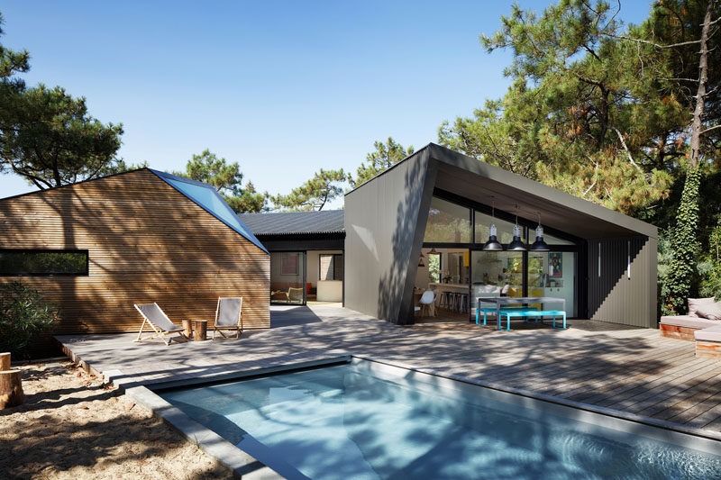 Atelier du Pont have designed a new a holiday house with swimming pool in Cap Ferret, France, that sits among a small forest of strawberry trees, yucca and pines.
