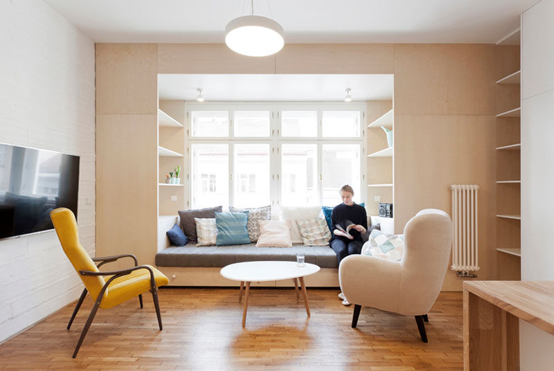 The Interior Designers Of This Apartment Included A Built-in Couch and Shelves By The Window