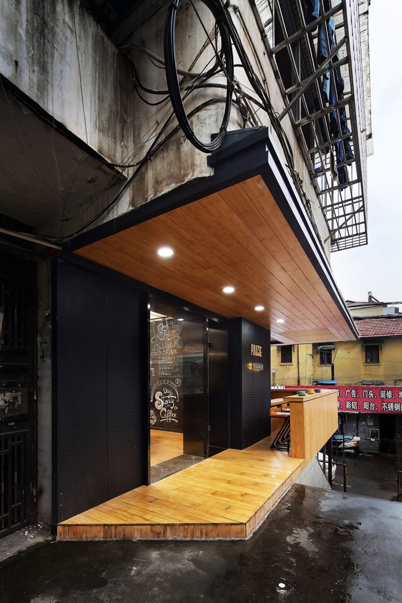 This modern coffee shop, full of matte black and bamboo elements, is nestled within a 1980s apartment building in China. #CoffeeShop #Cafe #ModernCoffeeShop #RetailDesign #InteriorDesign #Architecture