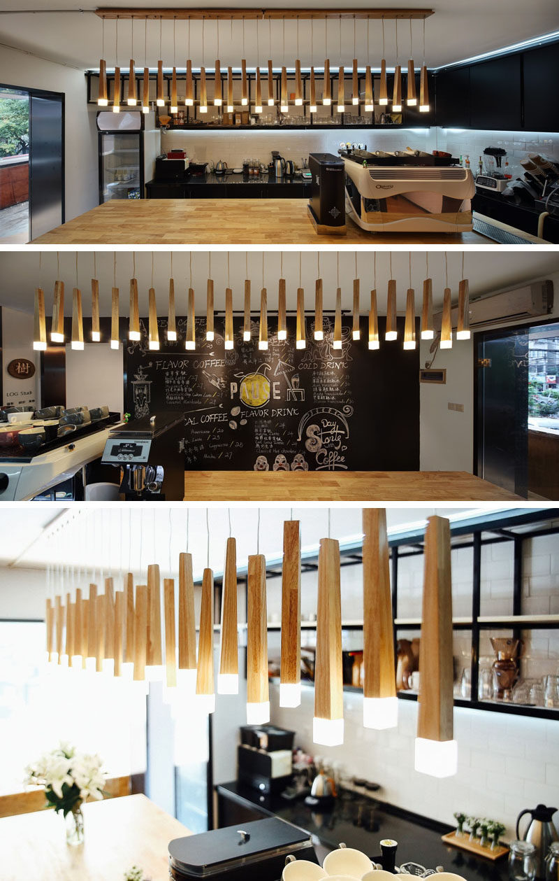 Hanging above the service bar in this modern coffee shop is an artistic lighting feature made from bamboo that has the ends lit up. #Lighting #CoffeeShop #Cafe #ModernCoffeeShop #RetailDesign #InteriorDesign