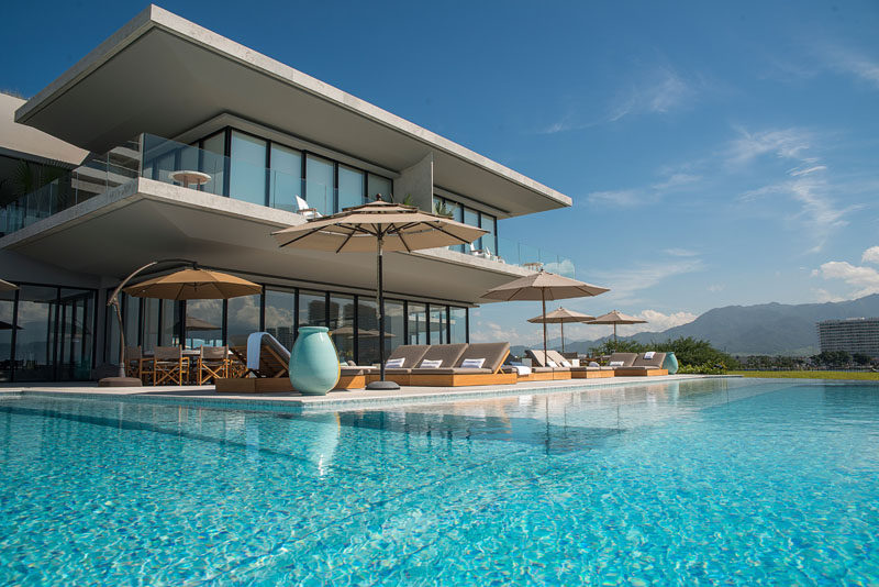 Architecture firm Ezequiel Farca + Cristina Grappin designed a waterfront home in Puerto Vallarta, Mexico, that features a large green roof and expansive outdoor entertaining spaces. #ModernHouse #GreenRoof #HouseDesign #WaterfrontHouse