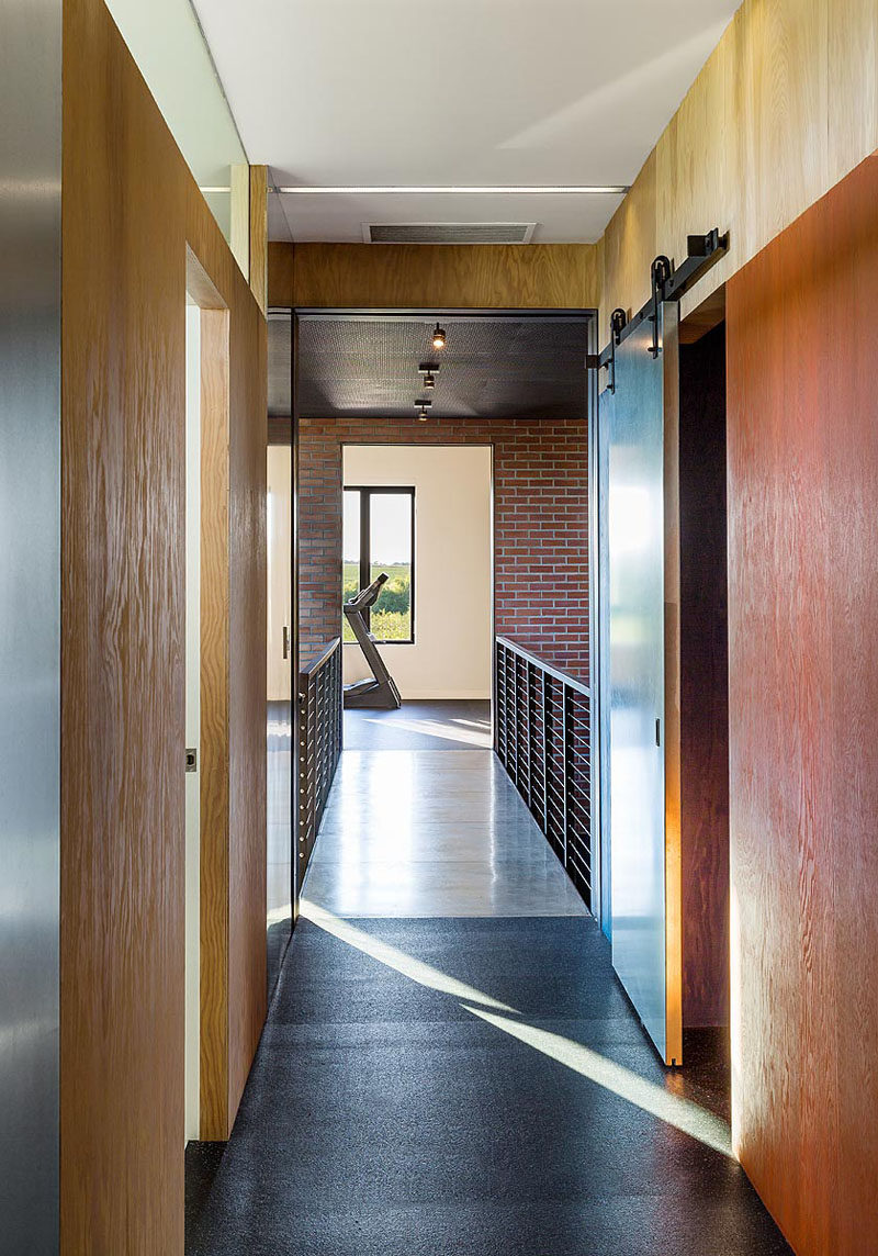 This industrial modern house has a bridge that separates the two wings of the house. #ModernHouse #InteriorBridge