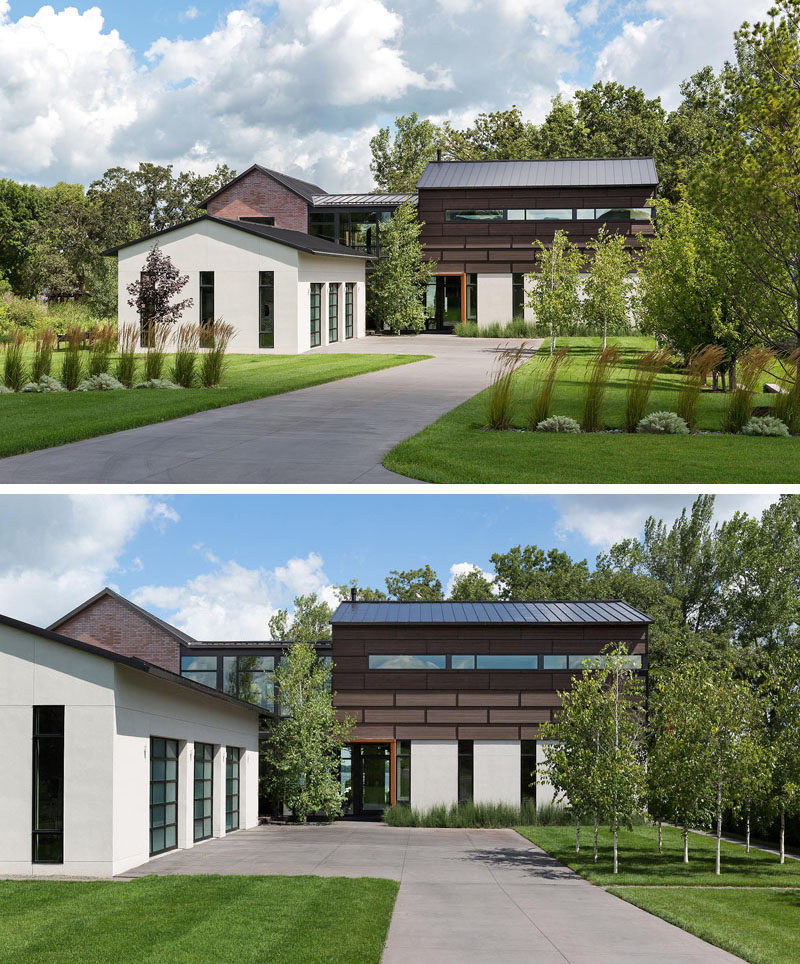 This industrial modern house, which is located next to a grove of 200 year old oak trees, has a landscaped front years with a driveway that leads to a garage. #IndustrialModern #HouseDesign #Driveway