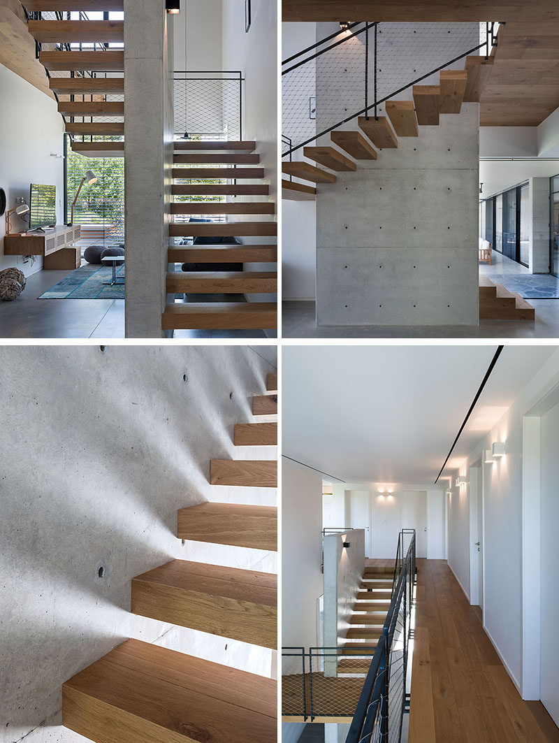 Wood stairs with a black steel and mesh handrail wrap around a concrete wall and lead to the second floor of this modern house. Upstairs, a wood walkway connects the various rooms. #ModernStairs #WoodStairs