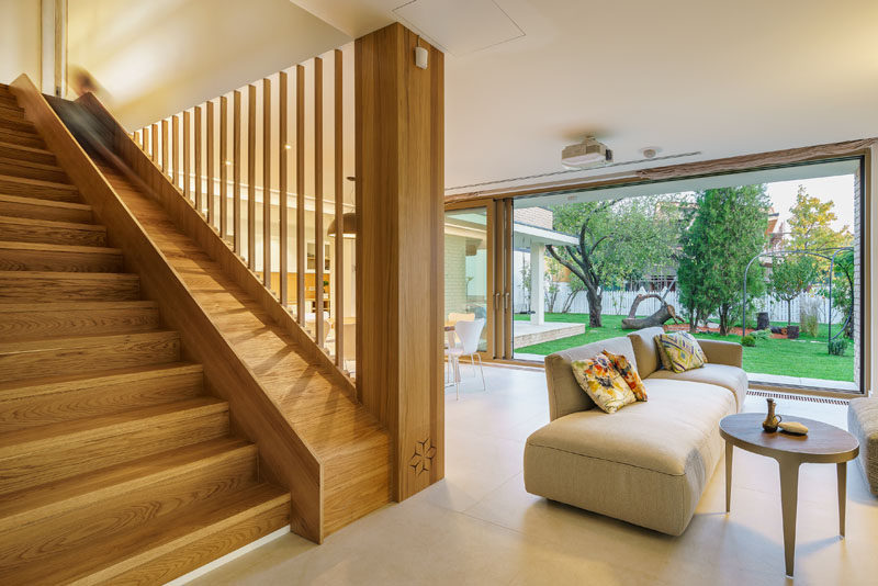 This modern house has wood stairs with a built-in slide for the kids in the family. #WoodStairs #ModernStairs #Slide