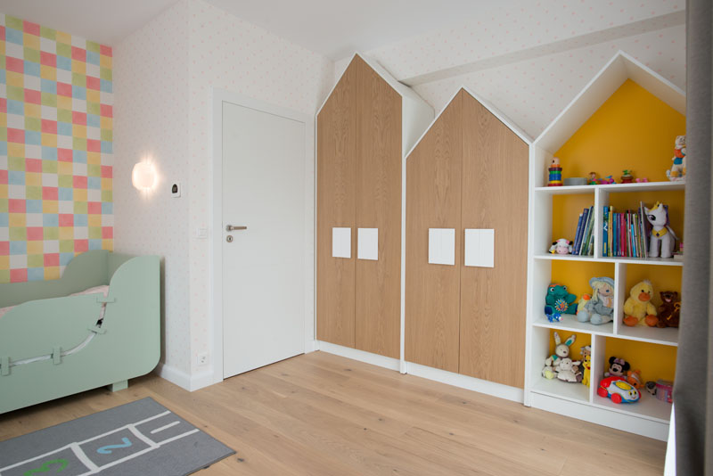 The handles on these house-shaped closet double as 'windows' and help to create a fun space for the child, but as they are larger than normal hardware found on cabinets, it also makes it easier for the child to open their closet. #Closets #Hardware #Cabinets #Handles